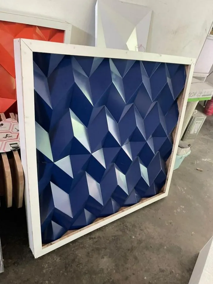 Blue ACP feature wall with a 3D diamond pattern