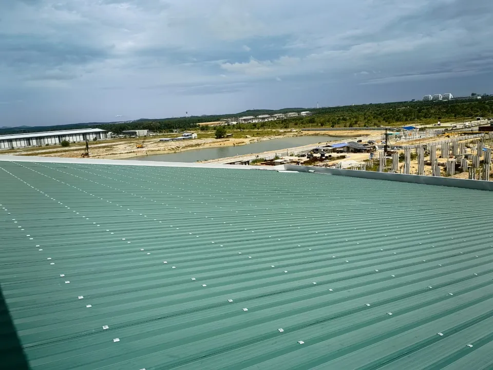 Green metal deck roof on a large building