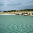 Green metal deck roof on a large building